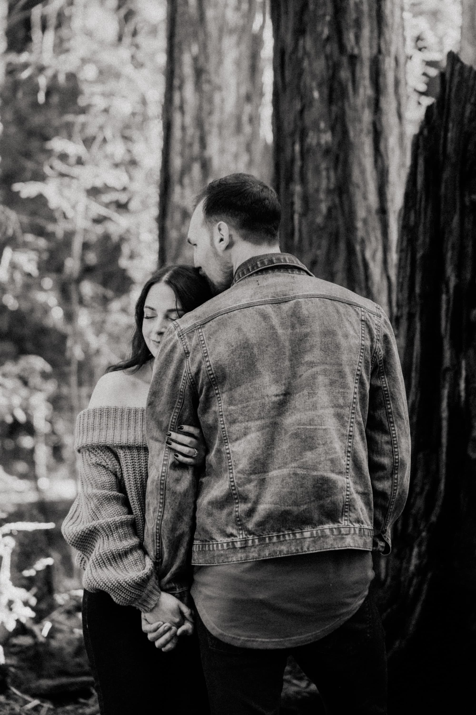 The couple share a sweet moment among the towering redwood trees at Henry Cowell Redwoods State Park.